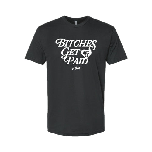 A black short-sleeve crewneck t-shirt with a white graphic print on the front reading 'BITCHES GET PAID' in a stylized font, with a small heart containing 'EST. 19' and 'HBM' underneath