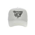 white trucker hat with black text saying Bitches Get Paid on white background
